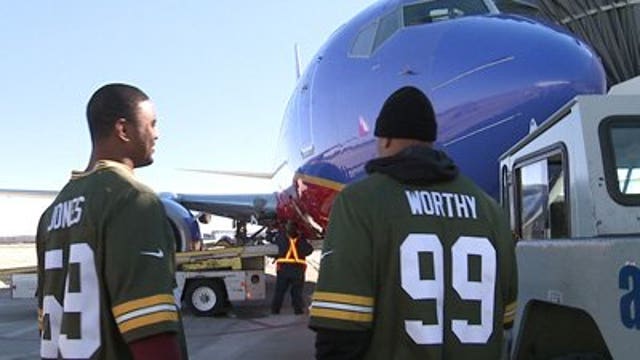 Packers Jerel Worthy and Brad Jones serve as Southwest Airlines employees