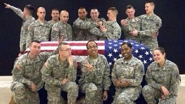 Two soldiers off funeral duty after photo flap