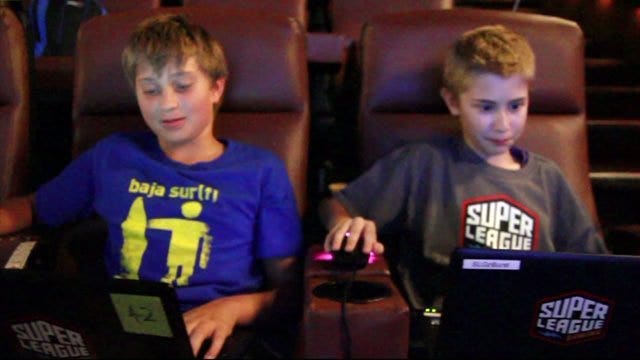 A new way to play video games is getting kids out of their rooms and into a more social setting