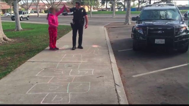 Police officer plays hopscotch with homeless girl in viral video