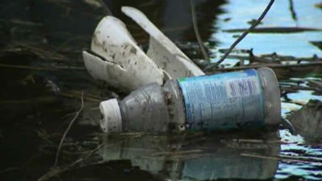 Trash frozen to the ground during winter making its way into Lake Michigan, rivers
