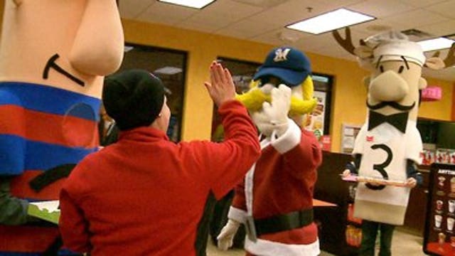 Brewers' racing sausages hand out goodies at Dunkin Donuts