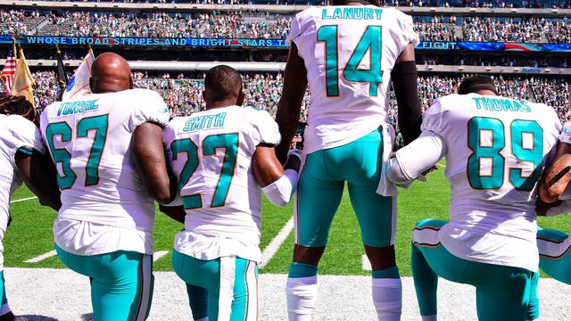 Do NFL rules require players to stand during the national anthem?