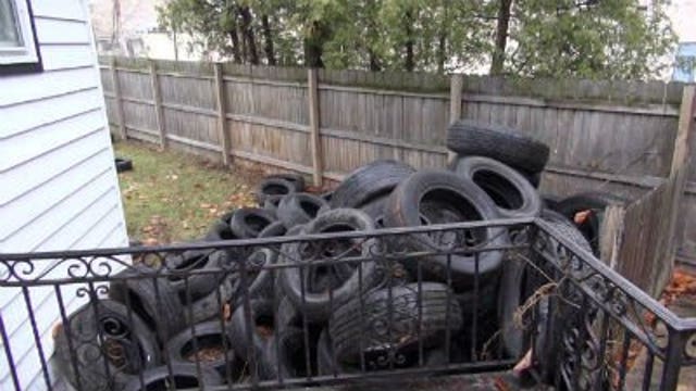 Racine couple returns from vacation to old tires dumped in yard