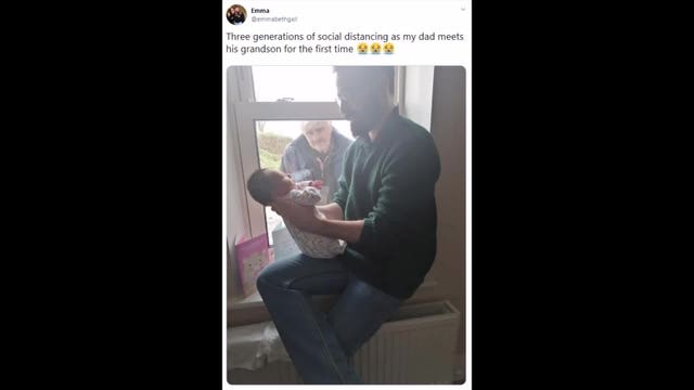 Grandfather meets newborn grandson for 1st time through a window
