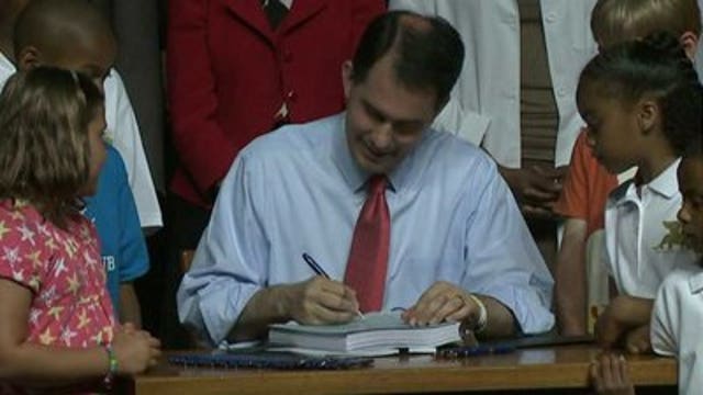 Gov. Scott Walker signs 2013-2015 state budget into law
