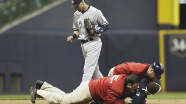 Milwaukee fan approaches Jeter at shortstop