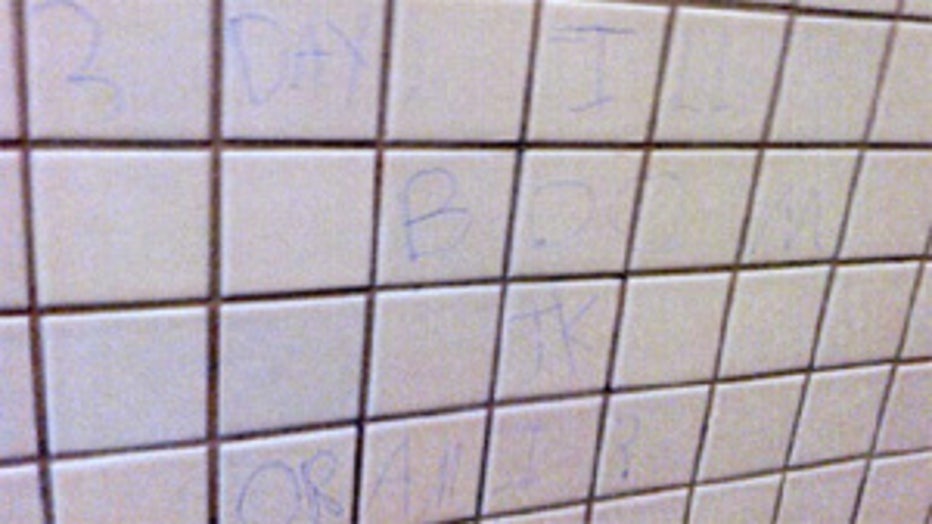 Threat written on bathroom wall at Greendale H.S. by Nicholas Olson