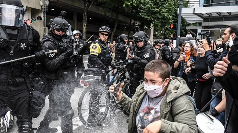 Arrests and shields, metal poles seized at Portland protests