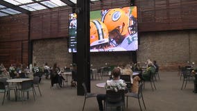 Packers fans, 'happy there's a season,' watch game at 'distanced tables'