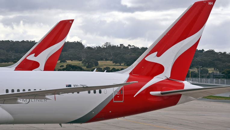 Two Qantas planes are seen at at Melbourne Airport on August 20, 2020. - Australian flag carrier Qantas on August 20, 2020 posted an almost 2 billion USD annual loss after a 