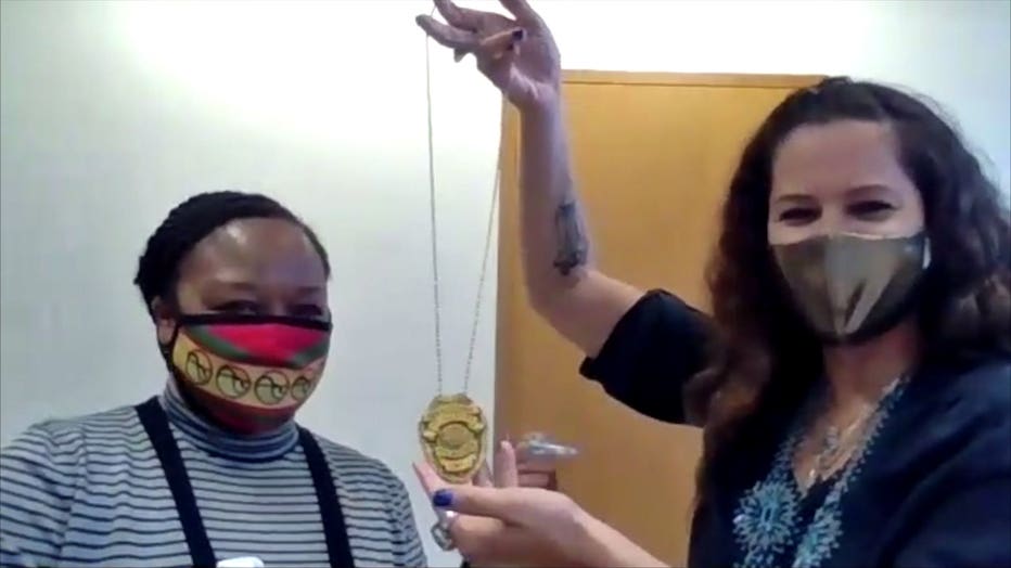 Marlaina Jackson (L) receives a badge from Jeanette Kowalik (R)