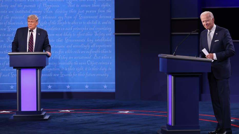 FILE - U.S. President Donald Trump and Democratic presidential nominee Joe Biden look out to the audience at end of the first presidential debate at the Health Education Campus of Case Western Reserve University on September 29, 2020 in Cleveland, Ohio.