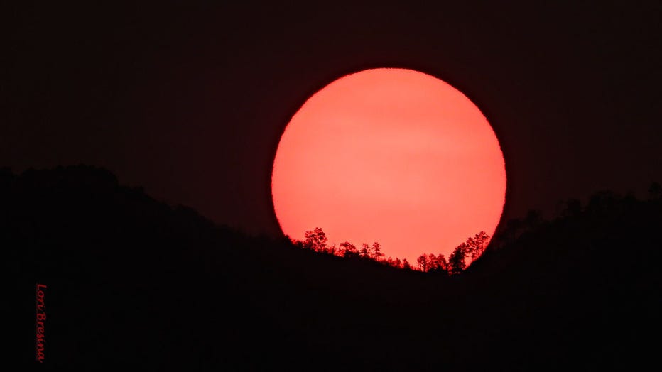 An eerie phenomenon: Wildfires cause sun, moon to glow red in