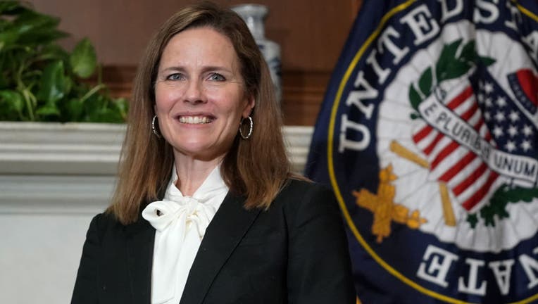 FILE - Seventh U.S. Circuit Court Judge Amy Coney Barrett, President Donald Trump's nominee for the U.S. Supreme Court, meets with Sen. Bill Cassidy (R-LA) as she prepares for her confirmation hearing, on Capitol Hill on October 1, 2020 in Washington, DC.