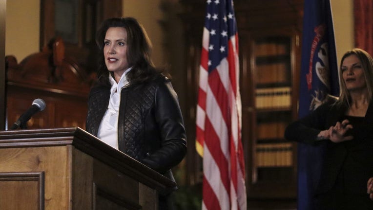 Gov. Gretchen Whitmer stands behind a podium in front of an American flag and addresses the public after a plot to kidnap her was unraveled.