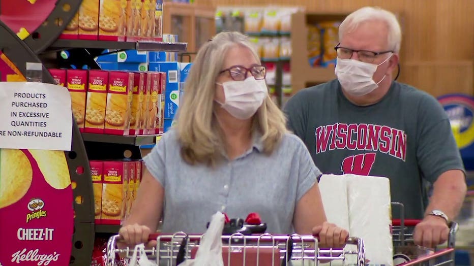 People wearing masks while grocery shopping in Wisconsin during the COVID-19 pandemic