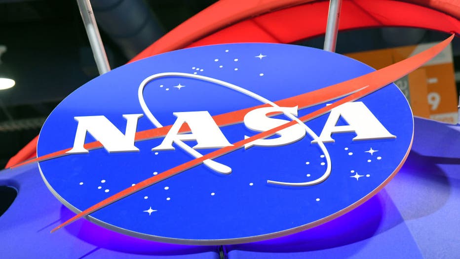 The NASA logo is displayed at the agency's booth during CES 2018 at the Las Vegas Convention Center on January 11, 2018 in Las Vegas, Nevada. The space agency said that an asteroid will make a close-approach to Earth on April 29. (Photo by Ethan Miller/Getty Images)