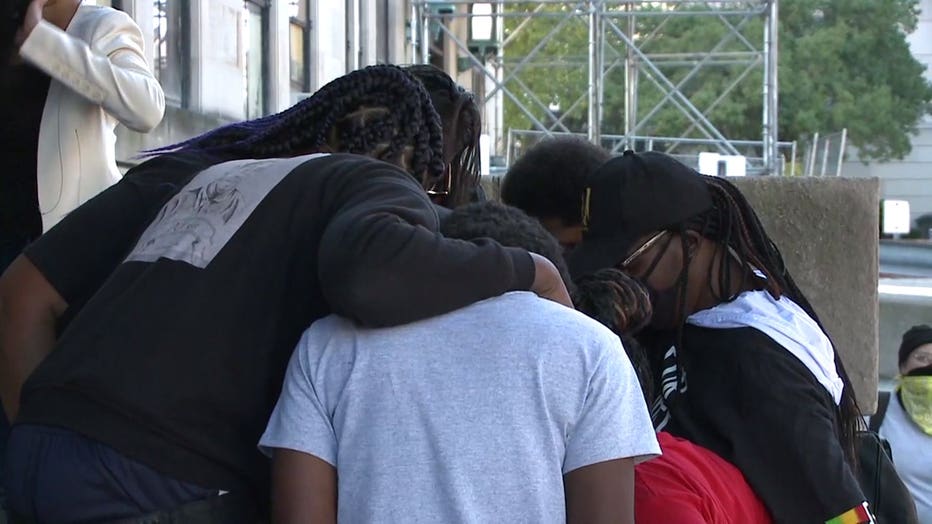 Alvin Cole's family prays before meeting with Milwaukee County District Attorney John Chisholm