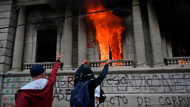 Protesters burn part of Guatemala's Congress building amid budget cuts to education, health spending