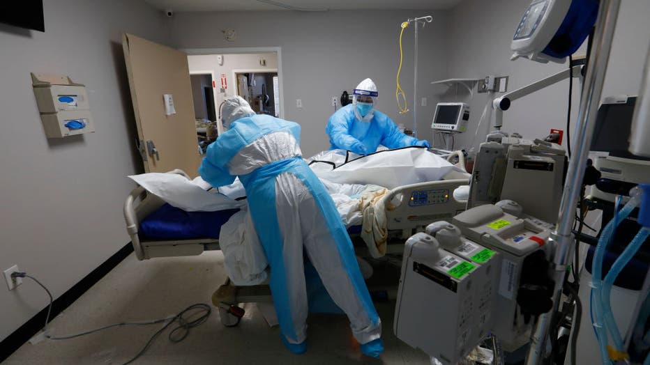 Dec. 9, 2020: Nurses ease a former COVID-19 patient into a body bag at a hospital in Houston, Texas. (Carolyn Cole / Los Angeles Times via Getty Images)