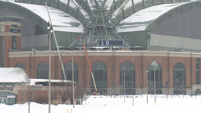 Crews work to place 52,000-pound sign on American Family Field