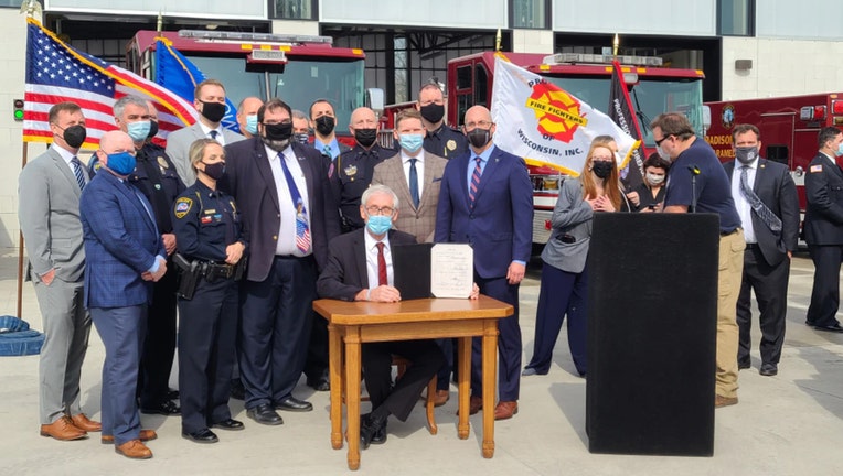 Gov. Tony Evers signs a bill to make it easier emergency responders suffering from post-traumatic stress disorder to file worker's compensation claims, on Tuesday, April 27, 2021.(WMTV-TV/Curt Lenz)