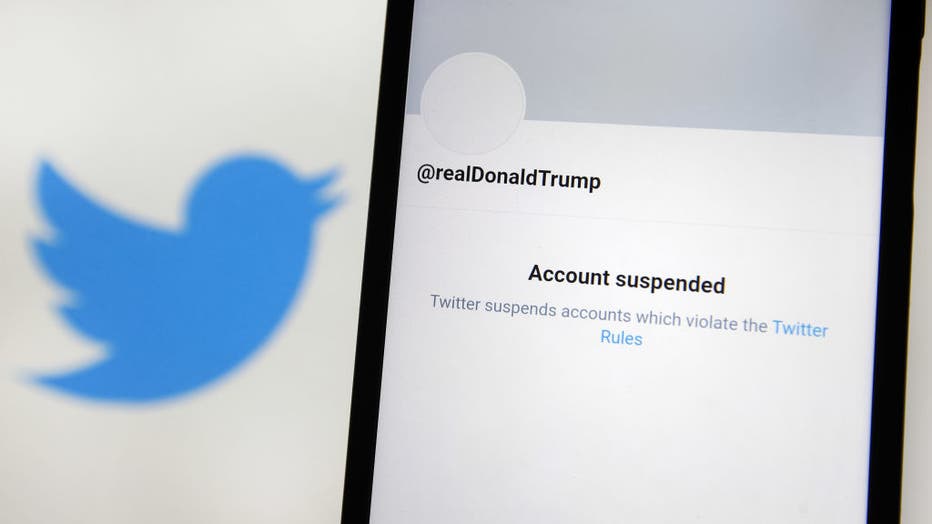 In this photo illustration, an 'Account suspended' message