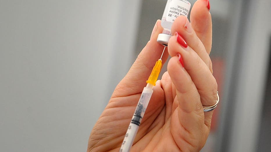 Nurse while preparing a dose of Pfizer vaccine, inside the