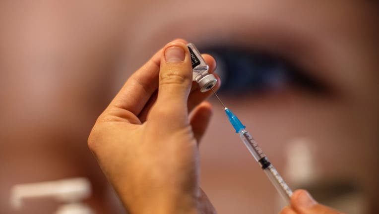 FILE - A medic fills up a syringe with a dose from a vial of the Pfizer-BioNTech COVID-19 vaccine at a vaccination center during a nationwide campaign on Jan. 11, 2021, in Jerusalem, Israel. (Photo by Ilia Yefimovich/picture alliance via Getty Images)