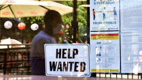 US unemployment claims drop to 385,000, another pandemic low