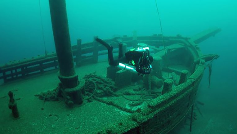 A diver swims over the two-masted schooner, Walter B. Allen, which sank in 1880. Credit: Tamara Thomsen, Wisconsin Historical Society