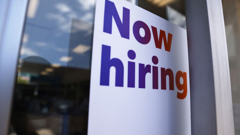 LOS ANGELES, CALIFORNIA - JUNE 23: A 'Now hiring' sign is displayed at a FedEx location on June 23, 2021, in Los Angeles, California. (Photo by Mario Tama/Getty Images)