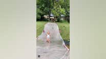 Dad with lightning-fast reflexes catches toddler on slip ‘n slide