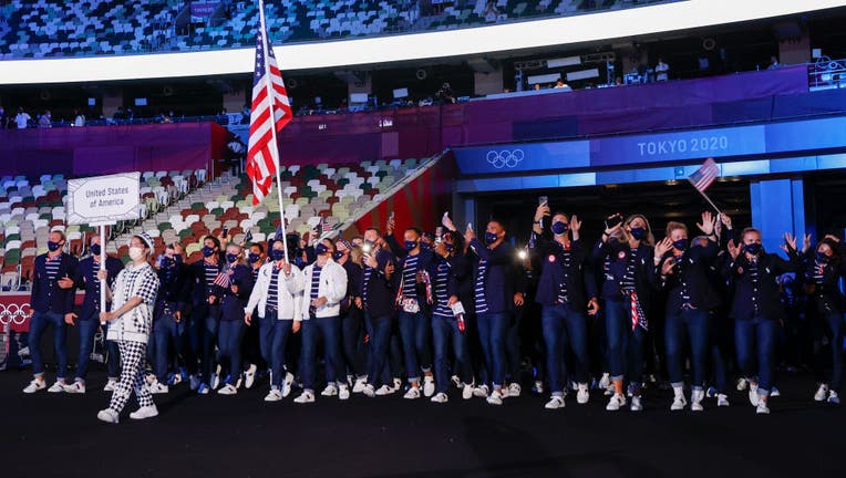 TOKYO, JAPAN - JULY 23: Flag bearers Sue Bird and Eddy Alvares of Team United States lead their team during the Opening Ceremony of the Tokyo 2020 Olympic Games at Olympic Stadium on July 23, 2021 in Tokyo, Japan. (Photo by Jamie Squire/Getty Images)