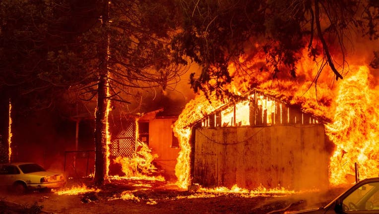 FILE - A home is engulfed in flames as the Dixie fire rages on in Greenville, California on August 5, 2021. (Photo by JOSH EDELSON/AFP via Getty Images)