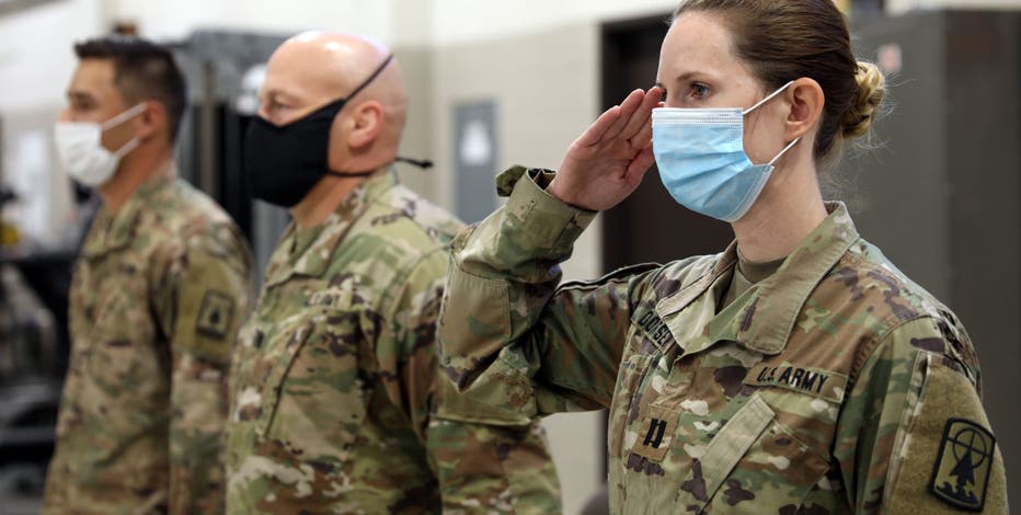 New Jersey National Guard soldiers render a salute during the Task