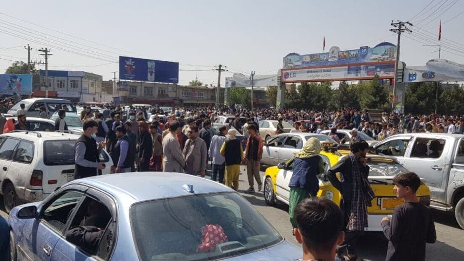 KABUL, AFGHANISTAN - AUGUST 16: Afghans crowd at the tarmac of the Kabul airport on August 16, 2021, to flee the country as the Taliban were in control of Afghanistan after President Ashraf Ghani fled the country. (Photo by Sayed Khodaiberdi Sadat/Anadolu Agency via Getty Images)