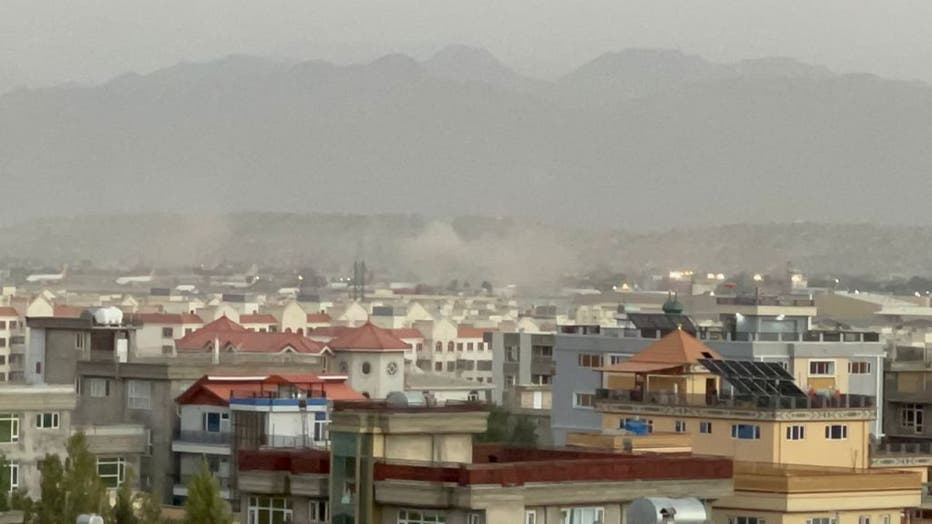 Smoke rises after two explosions reported outside Hamid Karzai International Airport, the center of evacuation efforts from Afghanistan since the Taliban took over in Kabul, Afghanistan on Aug. 26, 2021. (Photo by Haroon Sabawoon/Anadolu Agency via Getty Images)