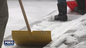 Wisconsin winter weather, shoveling ice and snow in West Bend