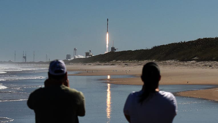 People watch from Canaveral National Seashore as a SpaceX