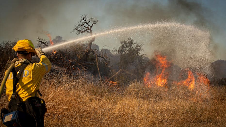 Bond Fire fueled by Santa Ana winds burns near Irvine Lake