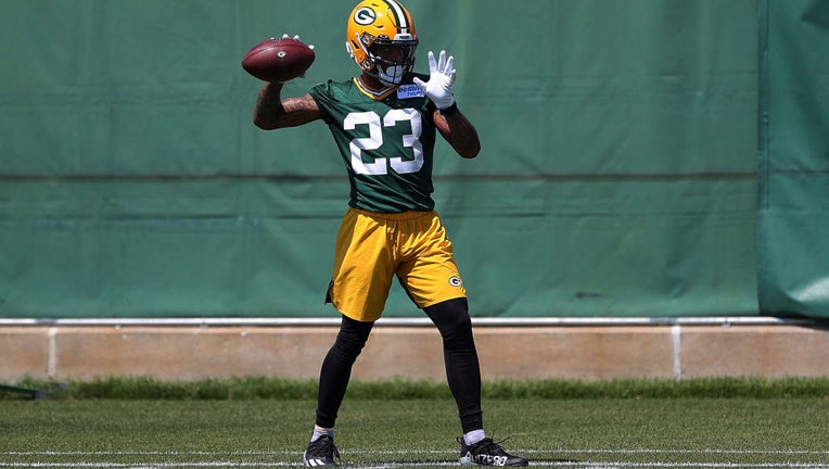 Jaire Alexander warms up before a Packers practice in Green Bay