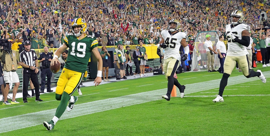 Green Bay Packers quarterback Danny Etling (19) runs for a touchdown during  an NFL Preseason game against the New Orleans Saints Friday, Aug. 19, 2022,  in Green Bay, Wis. (AP Photo/Jeffrey Phelps