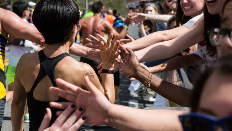 Crowds Gather Along Route of Boston Marathon To Cheer On Runners