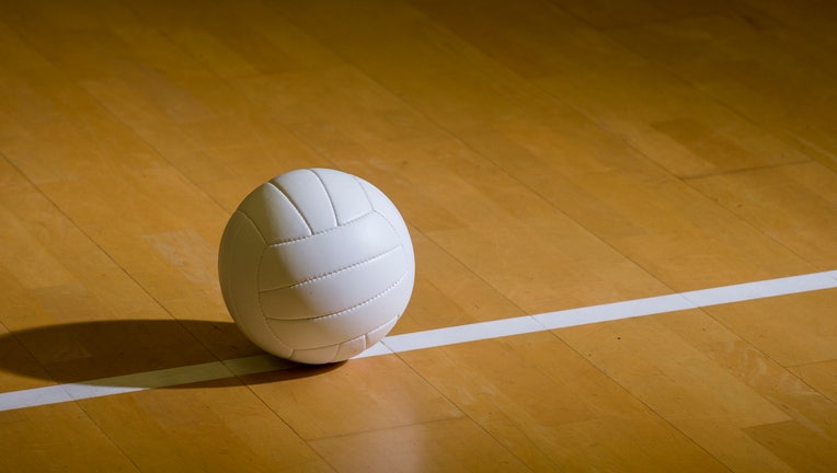 Volleyball court wooden floor with ball on black with copy-space