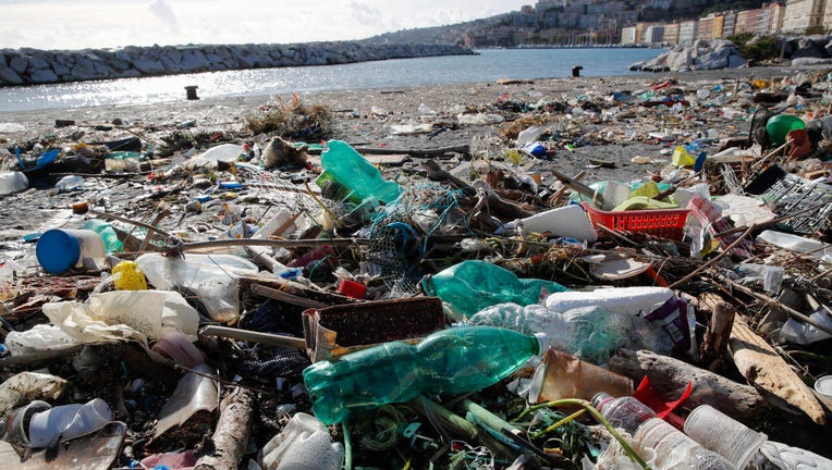 Plastic waste and debris washed up on the beach by recent