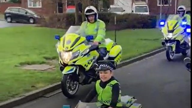 Boy who lost father fulfills wish to lead police patrol on toy bike