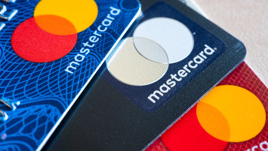 In this photo illustration there are three Mastercard Credit