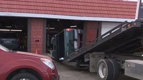 Currie Park Auto accident; driver crashed through overhead door, hit car lift